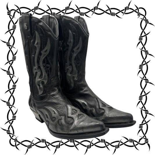 Black cowboy boots with intricate designs on a white background with barbed wire border.