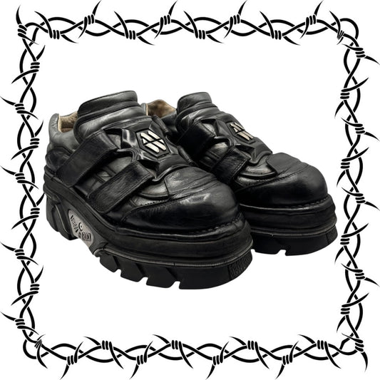 Pair of New Rock black platform shoes with a barbed wire border