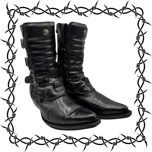 Pair of cowboy black leather boots with decorative elements on a barbed wire border.
